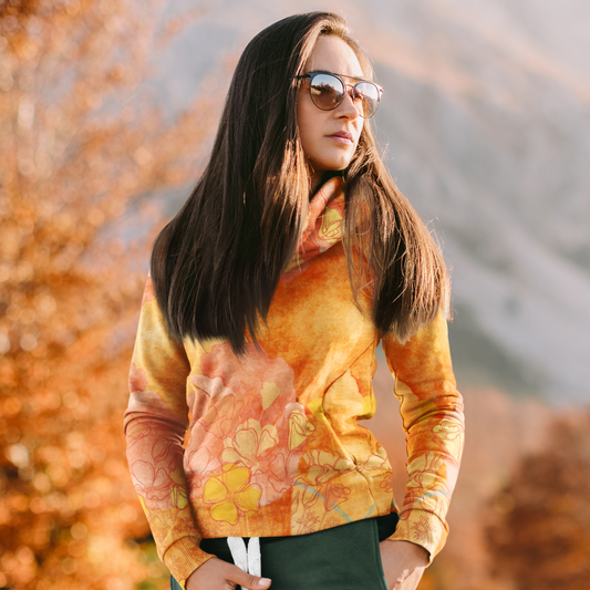 A cozy Women's California Orange Poppy Beach Hoodie by Chameleon Surf, featuring a vibrant orange poppy design. Made from 95% recycled polyester and 5% spandex, this hoodie has a soft cotton-feel fabric on the outside and a brushed fleece interior for extra warmth. It features a relaxed fit, double-lined hood with design on both sides, and drawstrings for a customizable fit. Perfect for beach bonfires, casual outings, or cozy nights in, this stylish and sustainable hoodie is a must-have for any beach lover.